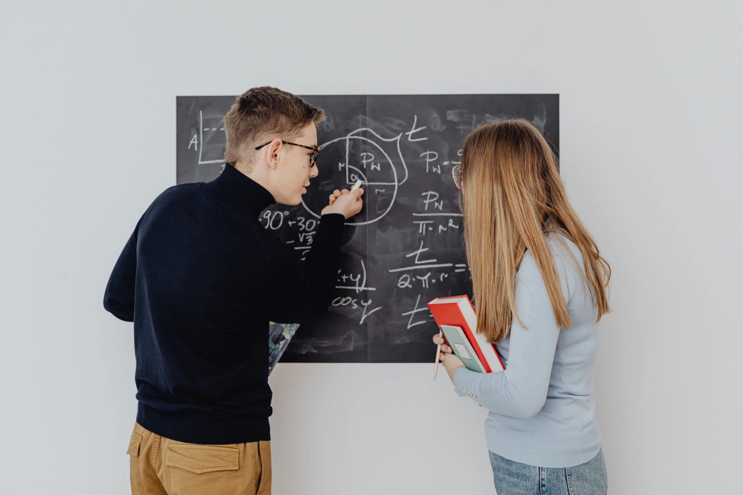 Tutor teaching at a blackboard