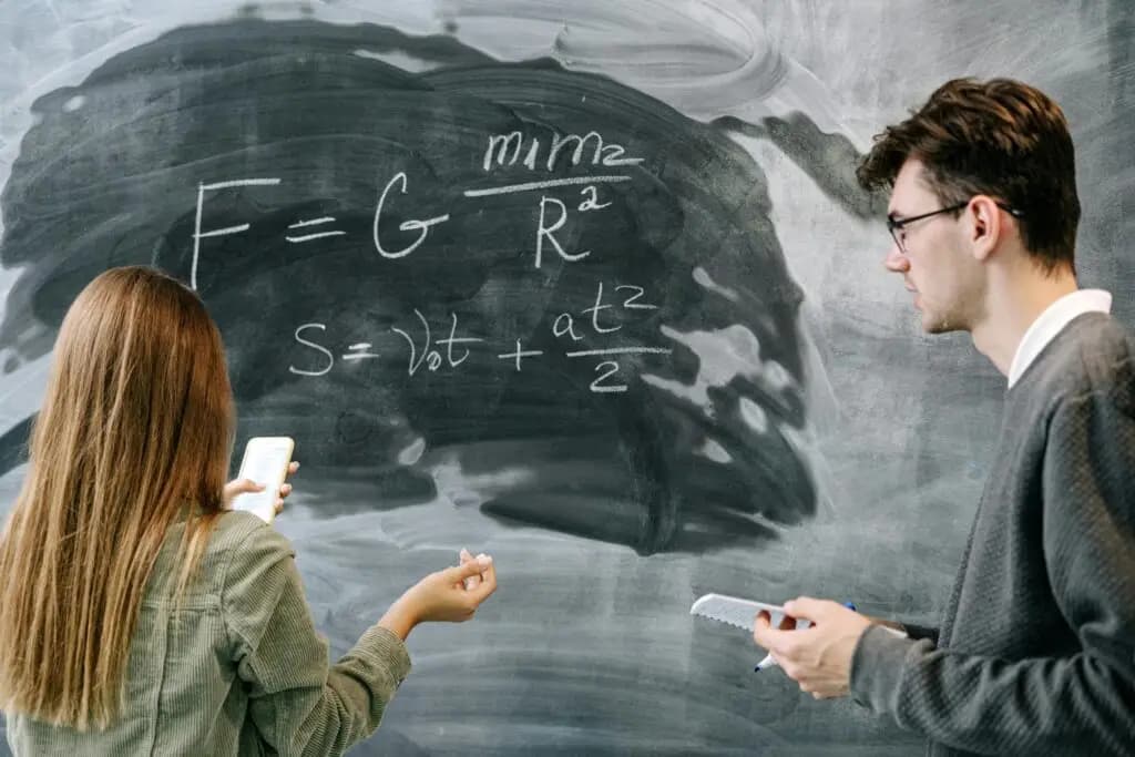 Physics tutor explaining formulas on a board